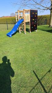 a shadow of a person standing next to a playground at Ferienwohnung Lampe in Altenberge