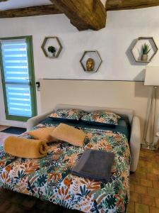 a bedroom with a bed with pillows and a window at Maisons de campagne. Gîte vert. in Brigné