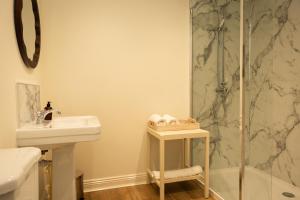 a bathroom with a shower and a sink at River View Cottages in Annan +32 photos