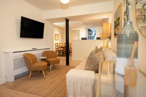 a living room with a couch and a dining room at River View Cottages in Annan