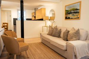 a living room with a couch and a kitchen at River View Cottages in Annan