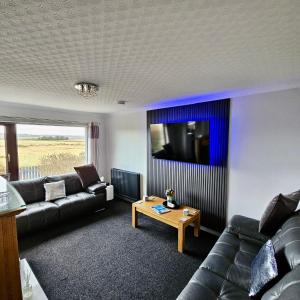 a living room with a couch and a table at BAYVIEW in Stornoway