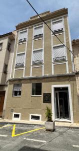 a largeartment building with a potted plant in front of it at Hospédate con Teo in Abarán +3 photos