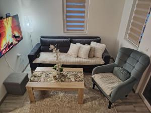 a living room with a couch and a coffee table at Kuca za Odmor ISKRA in Mokra Gora
