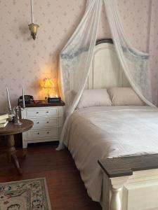a bedroom with a bed with a mosquito net at 221B Baker in Ấp Phú Thọ +15 photos