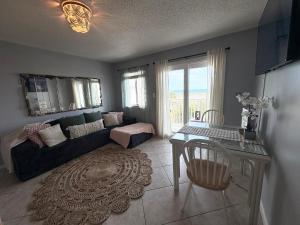 a living room with a couch and a table at Stay beachy in Gulf Shores