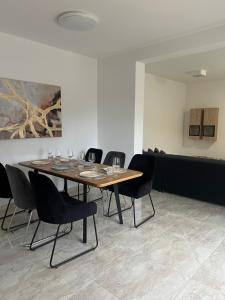 a dining room with a table with chairs and a painting at Modern Home Ula in Brtonigla
