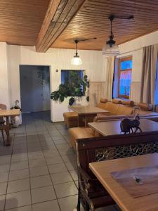 a living room with tables and a cat on the counter at Rhöner Sternenhimmel FeWo 1 und 2 in Frankenheim