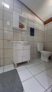 a bathroom with a sink and a toilet at Morada Caminho do Mar in Praia do Rosa +60 photos