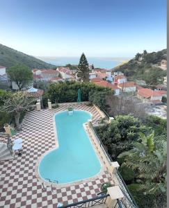an overhead view of a swimming pool in a resort at Villa Tzitzifies in Kouroukláta