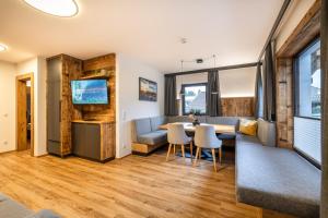 a living room with a couch and a table at Aparthotel Fuxbau in Flachau