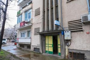 a building with colorful doors on the side of it at Solaris Apartment in Bitola
