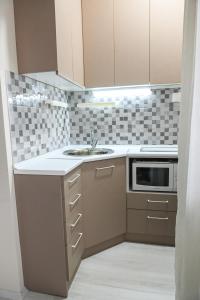 a kitchen with a sink and a microwave at Solaris Apartment in Bitola