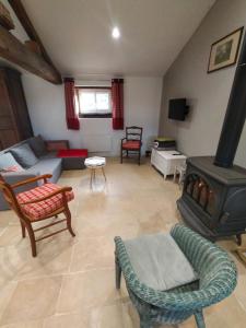 a living room with a couch and a fireplace at La bergerie de Genouse in Marnay
