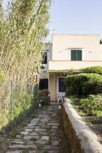 a house with a stone path in front of a building at La Cantina in Ventotene