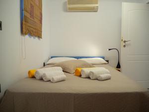 a bedroom with a bed with towels on it at Villa Tzitzifies in Kouroukláta +45 photos