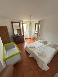 a bedroom with two beds and a mirror at Maison Lama in Lama +24 photos