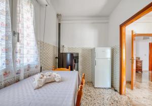 a bedroom with a bed and a refrigerator at La Residenza dell'Arrotino in Capitan Loreto