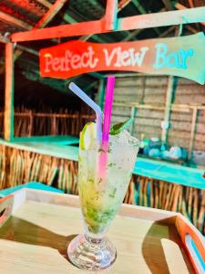 a drink sitting on top of a wooden table at Perfect view mirissa in Mirissa +61 photos