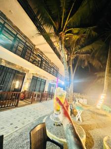 a person sitting at a table with a drink at Perfect view mirissa in Mirissa