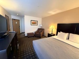 a hotel room with a bed and a chair at Quality Inn Zion Park Area in Hurricane