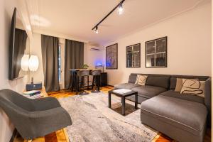 a living room with a couch and a table at Hotel Bojatours in Podgorica