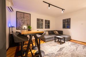 a living room with a couch and a table at Hotel Bojatours in Podgorica