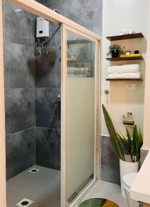 a shower with a glass door in a bathroom at Cara Studio Mactan Cebu Cozy with Garden View at Primeworld District Tower H 103 in Lapu Lapu City +20 photos