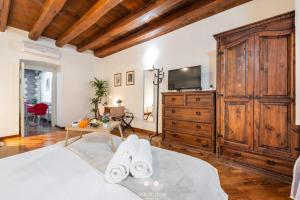 a bedroom with a large wooden dresser and a tv at Casa Vacanza Pablo Castello in Cagliari