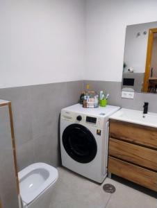 a bathroom with a washing machine and a sink at Casanova in Calpe +8 photos