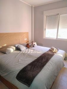 a large bed in a bedroom with a window at Casanova in Calpe