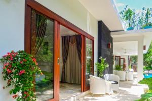 a glass door of a house with a patio at Villa Collard in Senggigi 