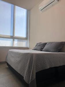 a bedroom with a bed and a large window at Departamento de Lujo, en el centro de Mty in Monterrey +19 photos