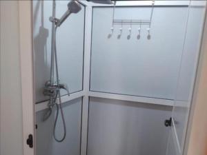 a shower in a white cabinet with a shower head at Luxury Dune's Camp in Merzouga