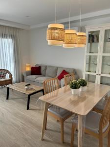 a living room with a table and a couch at Arguineguín sol y playa in Arguineguín