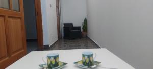 two cups sitting on a table in an office at Gáldar-Centro in Gáldar +9 photos