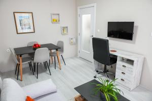 a living room with a table and a television at Solaris Apartment in Bitola