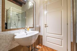 a bathroom with a white sink and a mirror at Casa Vacanza Pablo Castello in Cagliari +50 photos