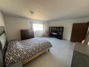 a bedroom with a bed and a dresser and a window at Casa Analco Durango in Durango