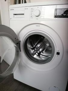 a white washing machine with its door open at X1 Chambre appartement T3 cohabitation partie commune et salon in Chambéry