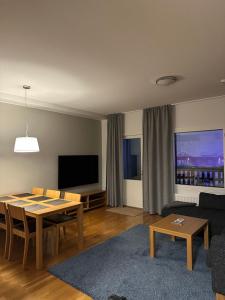 a living room with a table and a couch at Chalets LumiHelmi 2 Ruka in Ruka