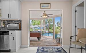 a kitchen with a door leading to a pool at Sunshine house on the canal in North Fort Myers