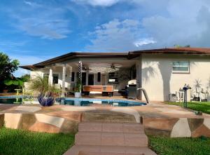 a house with a swimming pool in the yard at Sunshine house on the canal in North Fort Myers