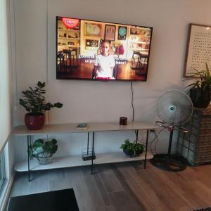 a living room with a tv on a wall at Charming and Relaxing Home in Guatemala +156 photos