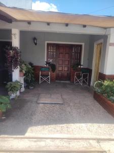 a front porch of a house with a wooden door at DepartamentosJYM in Federación