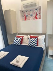a bedroom with a blue bed with towels on it at D&D Lovely central room in Capri