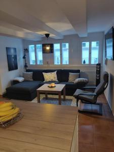 a living room with a couch and a table at Haus-Salamander-mit-Sauna in Wildemann