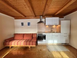 a kitchen with a couch in the middle of a room at Niedermaier Hof in Bad Birnbach