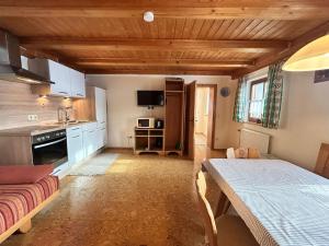 a kitchen with a table and a dining room at Niedermaier Hof in Bad Birnbach