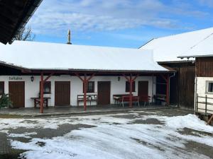 a house with snow on the roof of it at Niedermaier Hof in Bad Birnbach